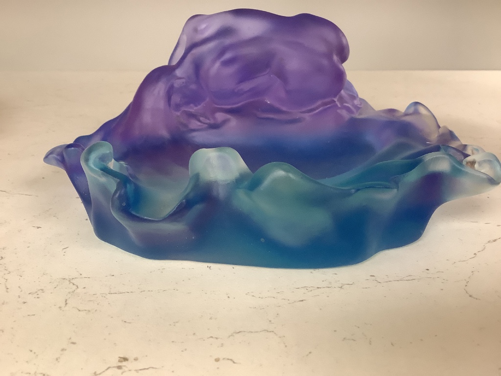 A blue and lilac glass dish with a kneeling nude, apocryphal Daum mark 18cm long